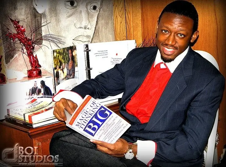 Dee Bright Jr. during his early entrepreneurial years holding The Magic of Thinking Big